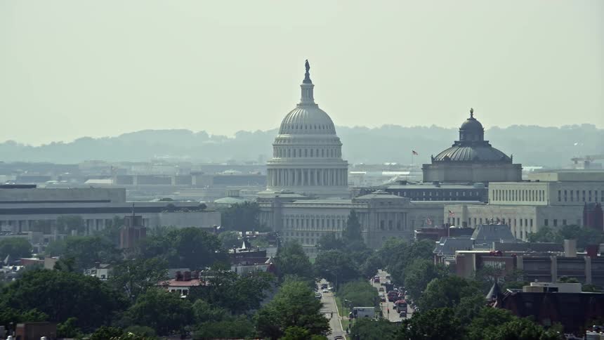 A stunning aerial view of the iconic United States Capitol dome situated between the James Madison and Thomas Jefferson buildings in Washington DC during daytime