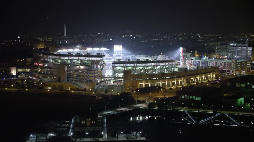 Aerial footage of Nationals Park during a lively baseball game under the clear night sky in Washington DC