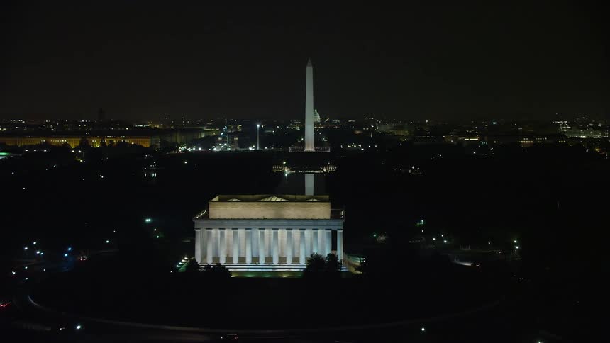 An stunning aerial view of Washington DCs famous monuments and government buildings illuminated at night