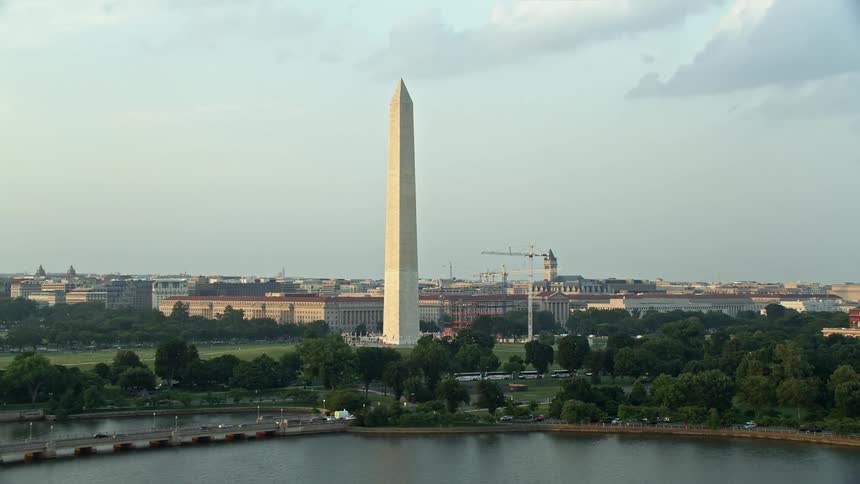 Aerial footage of the Washington Monument during sunset seen from the Tidal Basin in Washington DC