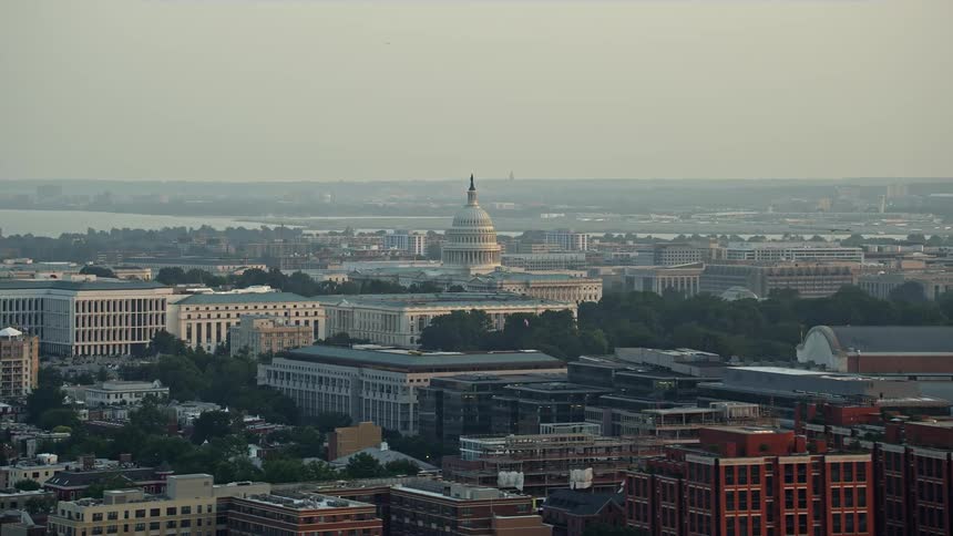 The sunset aerial footage captures the iconic United States Capitol building behind the Russell Senate Office Building in Washington DC