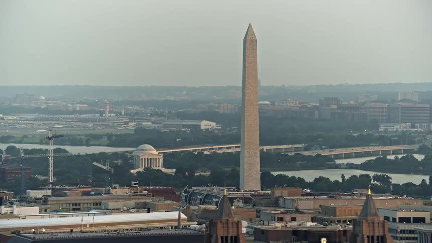 An aerial shot of the Jefferson Memorial and the Washington Monument during sunset in Washington DC showcasing the famous landmarks