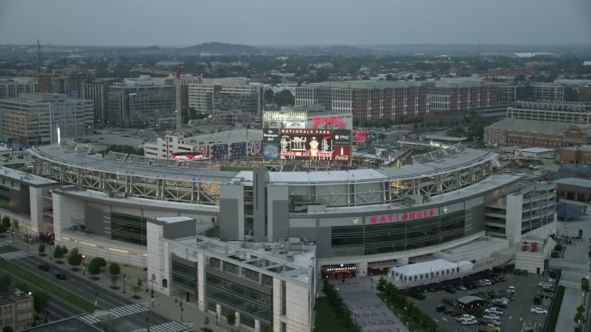Aerial footage of Washington DCs Nationals Park baseball stadium during twilight packed with spectators