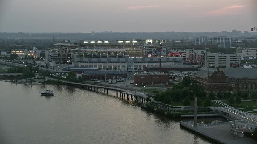 Aerial footage approaching Nationals Park from the Anacostia River during a baseball game in Washington DC at twilight