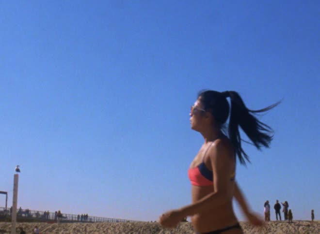 Woman playing volleyball with a crowd behind her