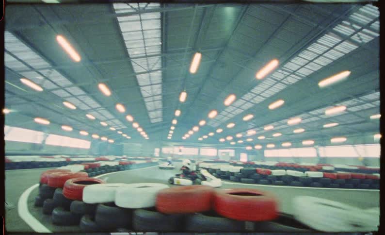 The interior of a race track with cars going around