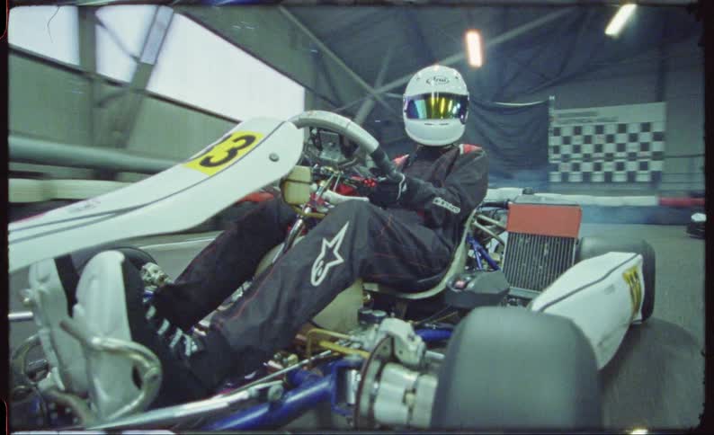 Gokart racer starts race and looks behind him to make sure hes not being caught