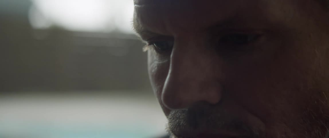 Close up view of a man sitting in a room is displayed
