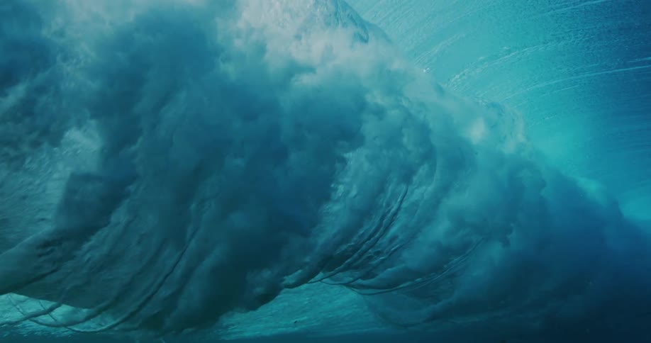 A large wave crashes underwater