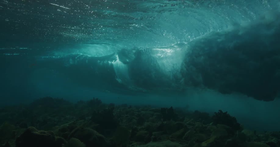 A wave crashes into the ocean