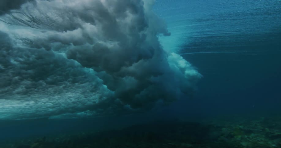 A large wave crashes in the ocean