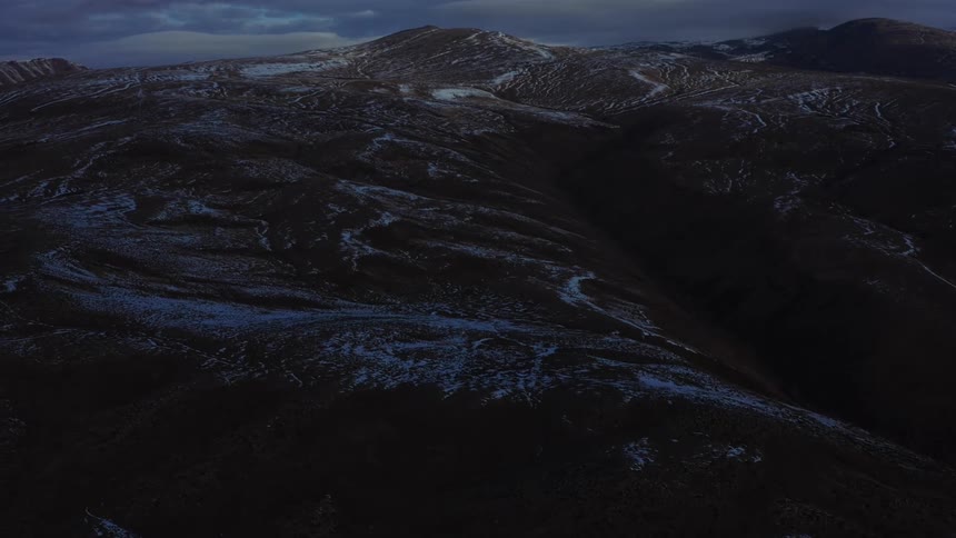 Aerial view of snowy mountains at dusk