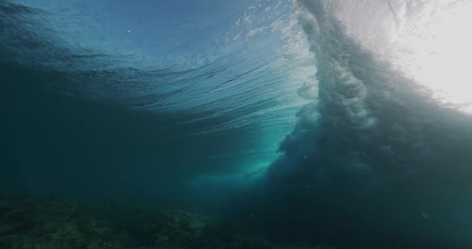 A tracking shot of a wave