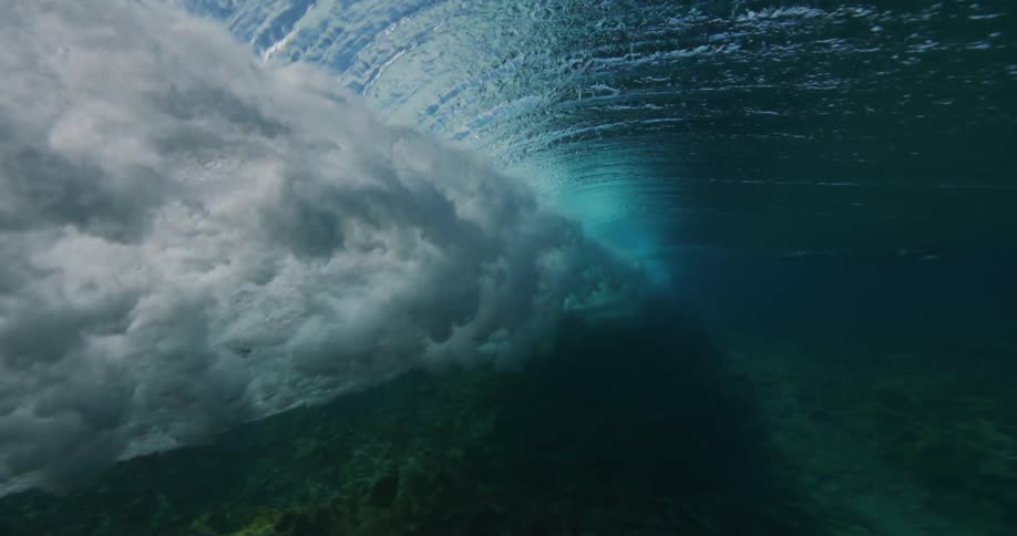The wave rolls underwater