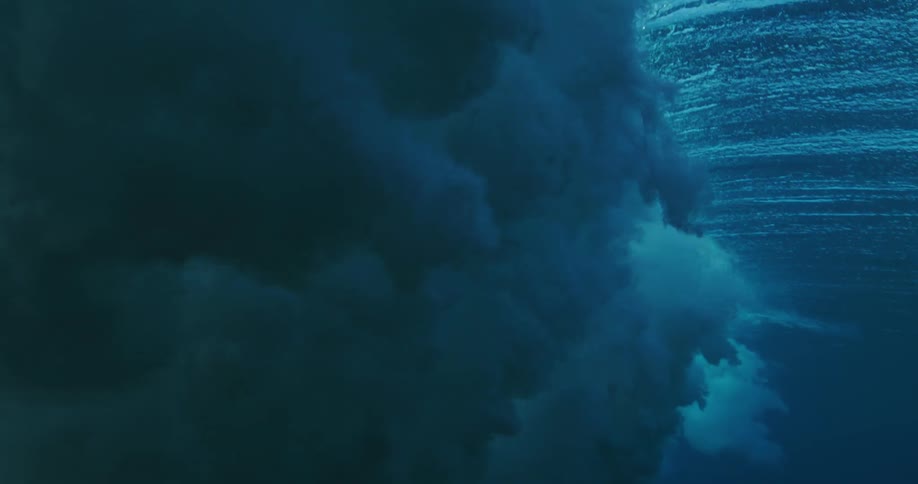 A large wave misses a turtle as it moves underwater