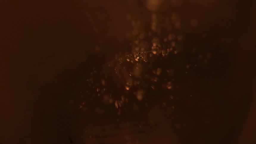 A view of liquid being poured into a glass