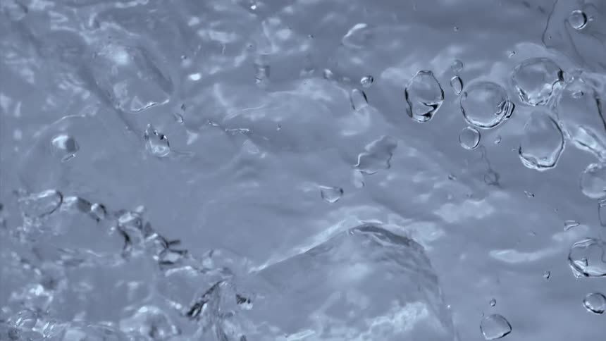 Water moves and splashes as bubbles rise to the top