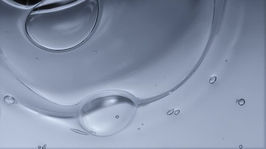 Water bubbles of varying sizes move across the surface