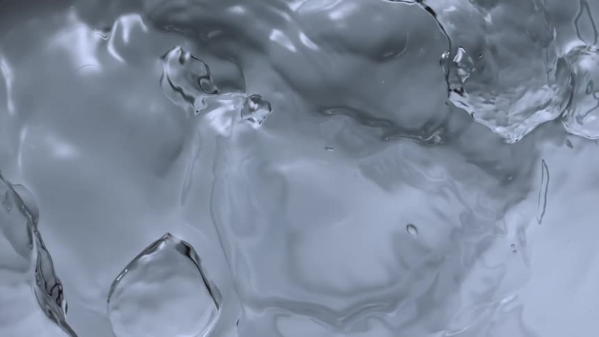 Bubbles in water are slowly moving as they rise to the surface