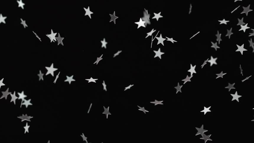 white stars are thrown across using only a black backdrop to highlight their travel