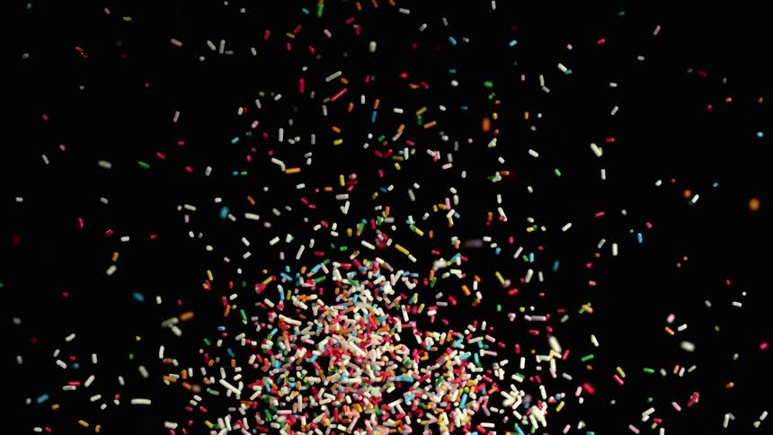 Colorful abstract pills are being thrown on black background