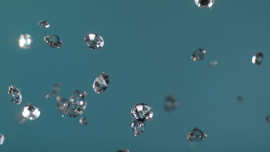 Diamonds fly into the air on a teal background