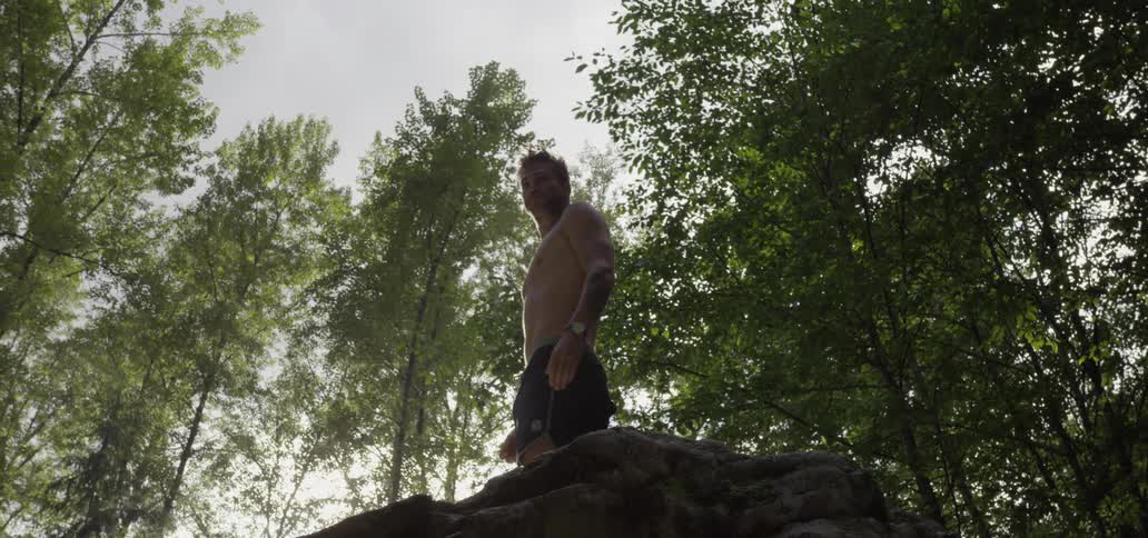 A man is standing on top of some rocks