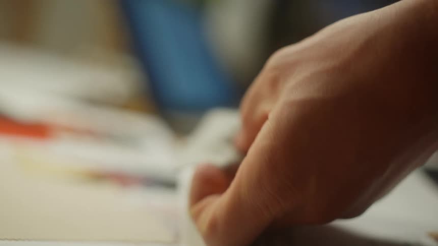 A man fondles swatches of fabric