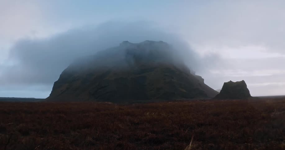 Thick fog settles over a mesa in a canyon