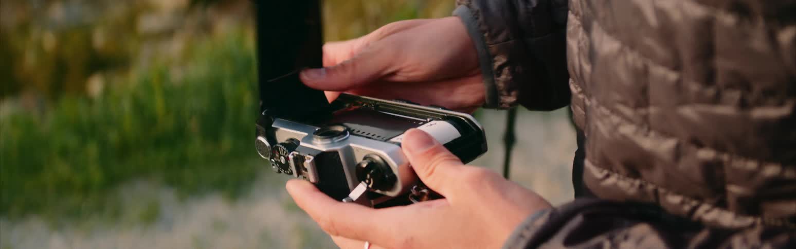 A person is checking their camera