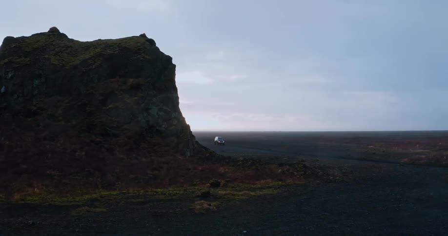 A rock and car coming into frame