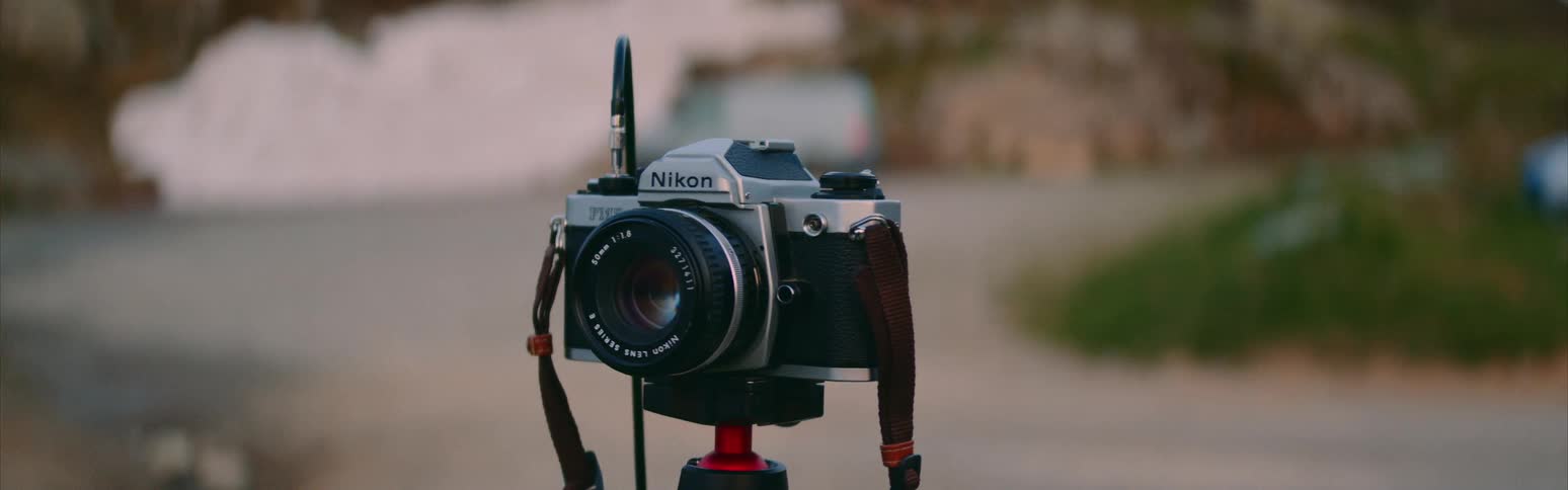 Camera on tripod points away from road and parking lot