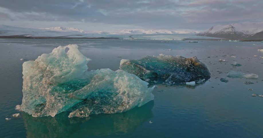 An aerial view of icebergs on a cloudy freezing day