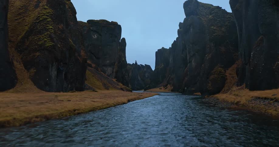 The stream is surrounded by large rock formations