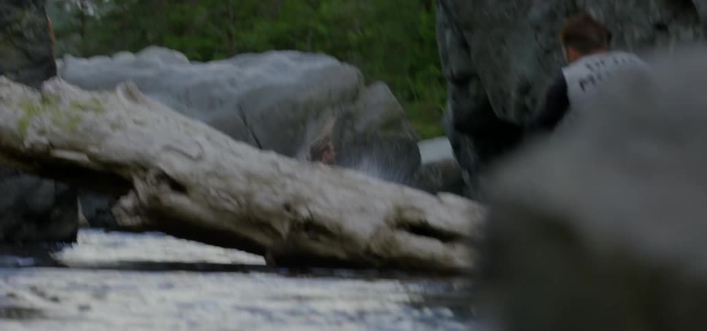 Man doing a flip from a rock into water