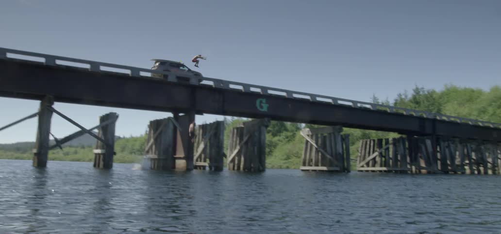 Three men jump into a river