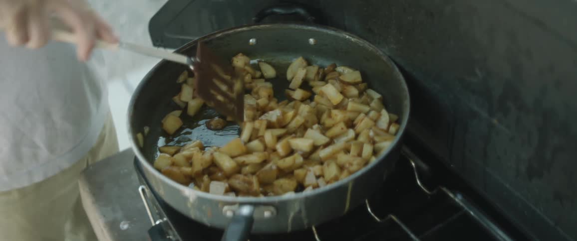 A person is cooking food in the pan