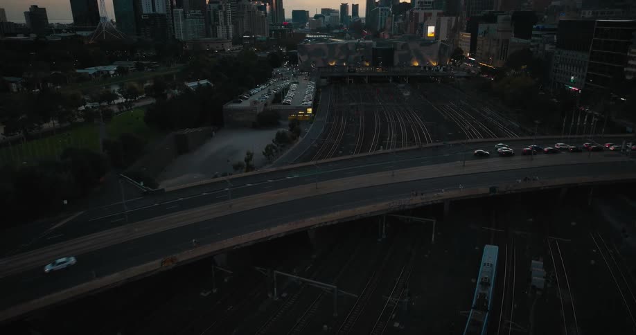 Cars and trains travel through the city