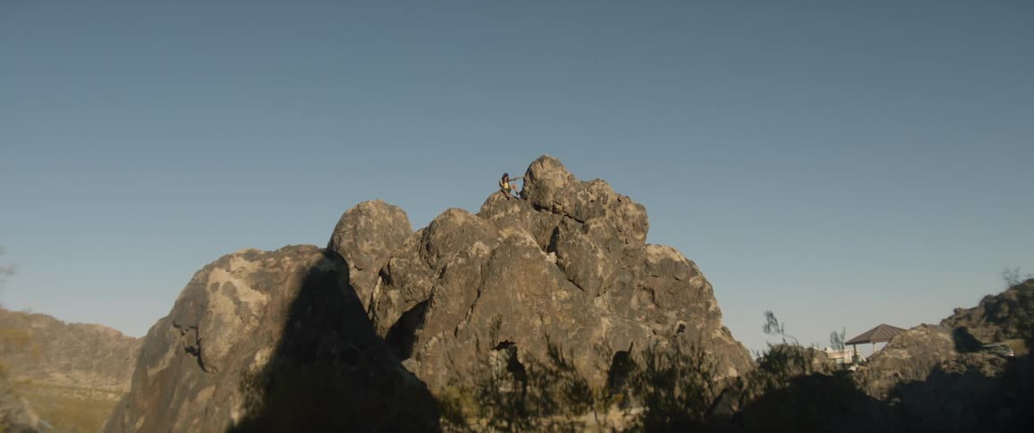 A person is perched on the mountain