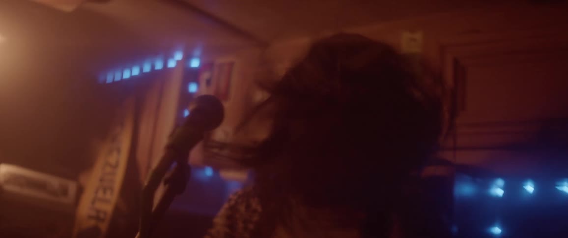 A person is playing the guitar in a room