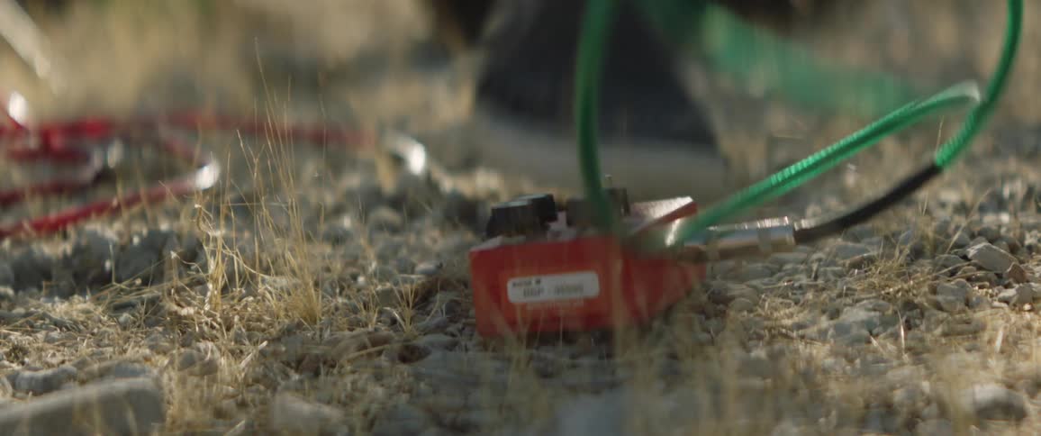 A man attaches a cable to an electrical box