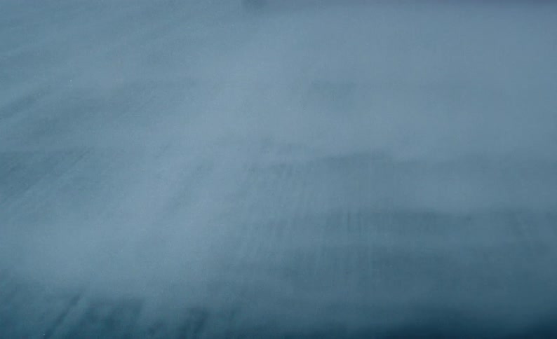 Close up view of a street covered in fog is displayed