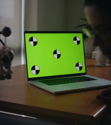 A woman is typing on a laptop and sitting indoors