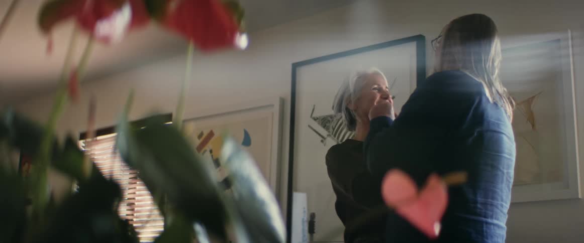 An elderly married couple is showing affection towards each other