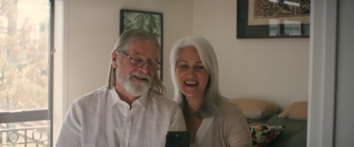 Two elderly people talking together