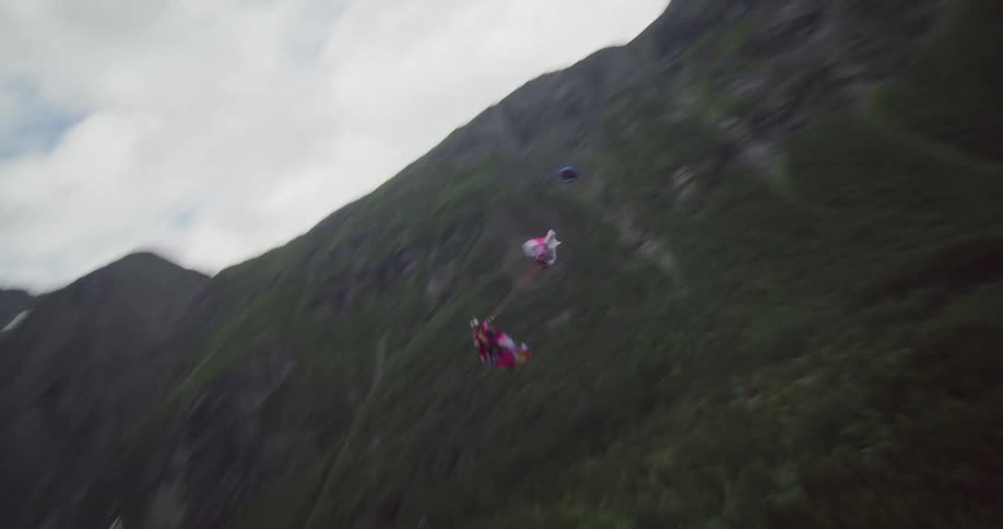 A person base jumping with a parachute