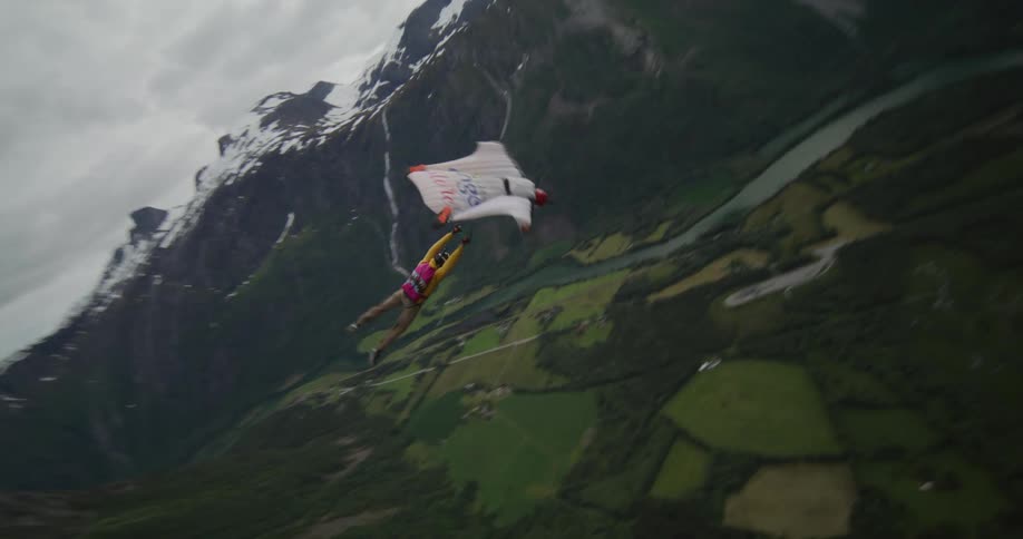 A person gliding down into a canyon