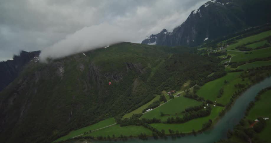 An aerial view of a river in a valley surrounded by hills
