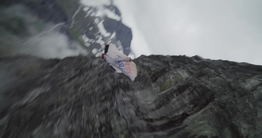 A person base jumping off a cliff