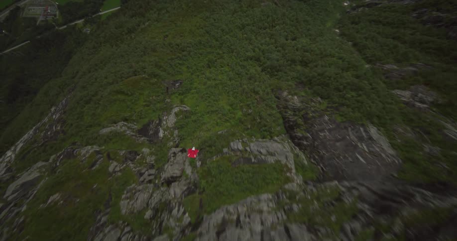 A person gliding over mountains on a summer day